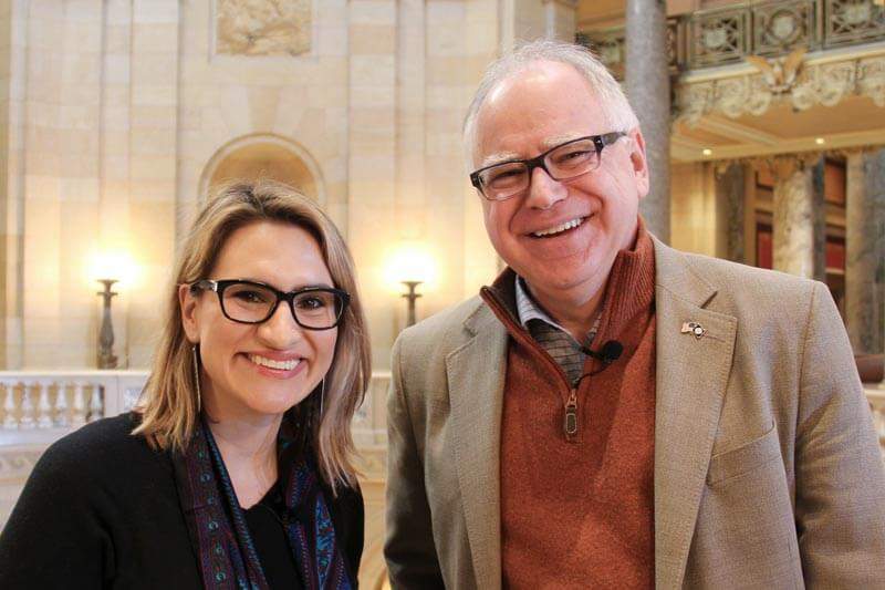 Governor Tim Walz and Lieutenant Governor Peggy Flanagan standing in the Minnesota State Capitol building.